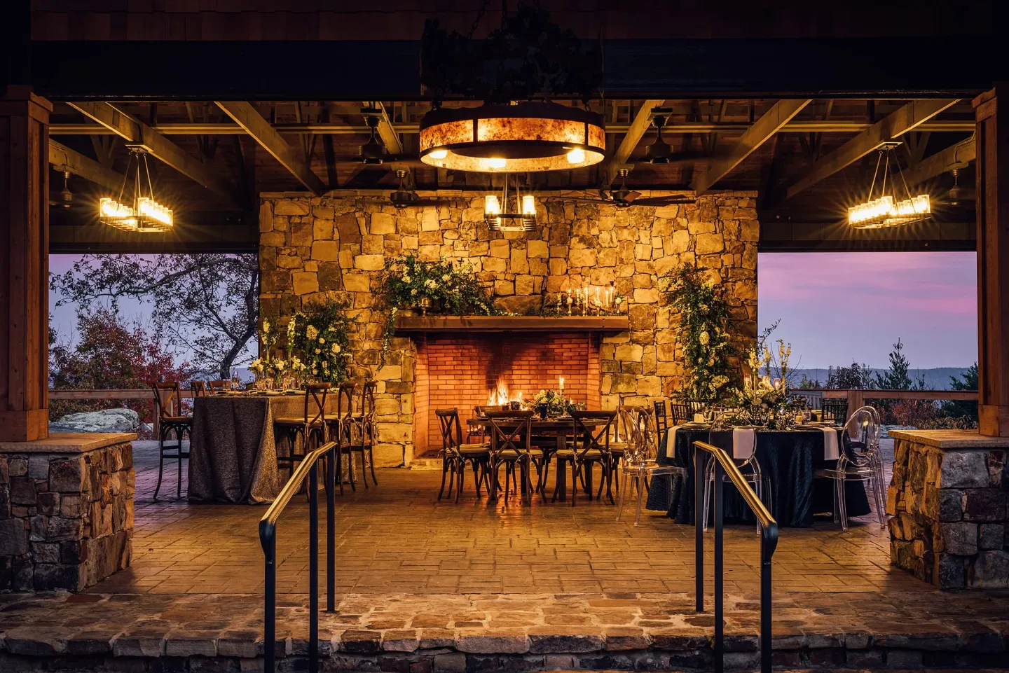 Cloudland’s stone fireplace pavilion set for dinner at dusk